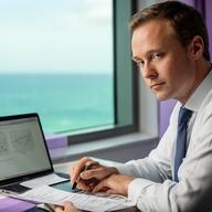 Financial advisor reviewing budget notes beside a laptop and sea-view window