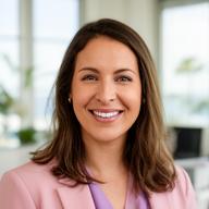 Professional financial advisor smiling in a bright Malibu office with soft daylight