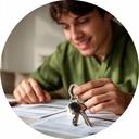 Young professional reviewing a condo budget with house keys on a table