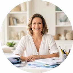 Aspacia Denherder smiling in a bright Malibu home office with budget folders on the desk